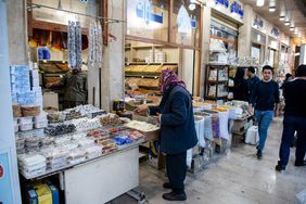 A man shopping in a street market in Iraq