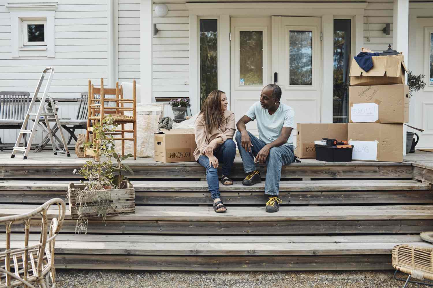Homebuyers with boxes on a porch