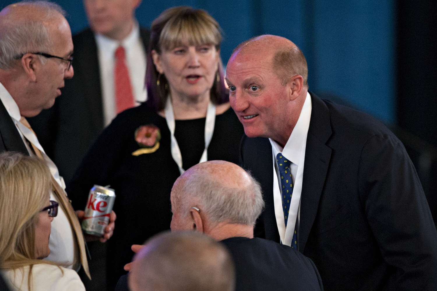 Greg Abel, chairman and chief executive officer of Berkshire Hathaway Energy Co., right, speaks with attendees before the start of the Berkshire Hathaway Inc. annual meeting in Omaha, Nebraska, U.S., on Saturday, May 6, 2017. 
