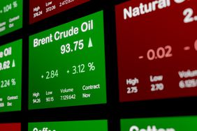 An exchange board displays the changing prices of Brent crude oil and natual gas for pricing forward contracts.