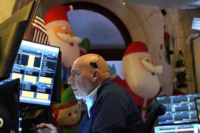 A trader works on the floor of the New York Stock Exchange (NYSE) at the opening bell on November 26, 2024