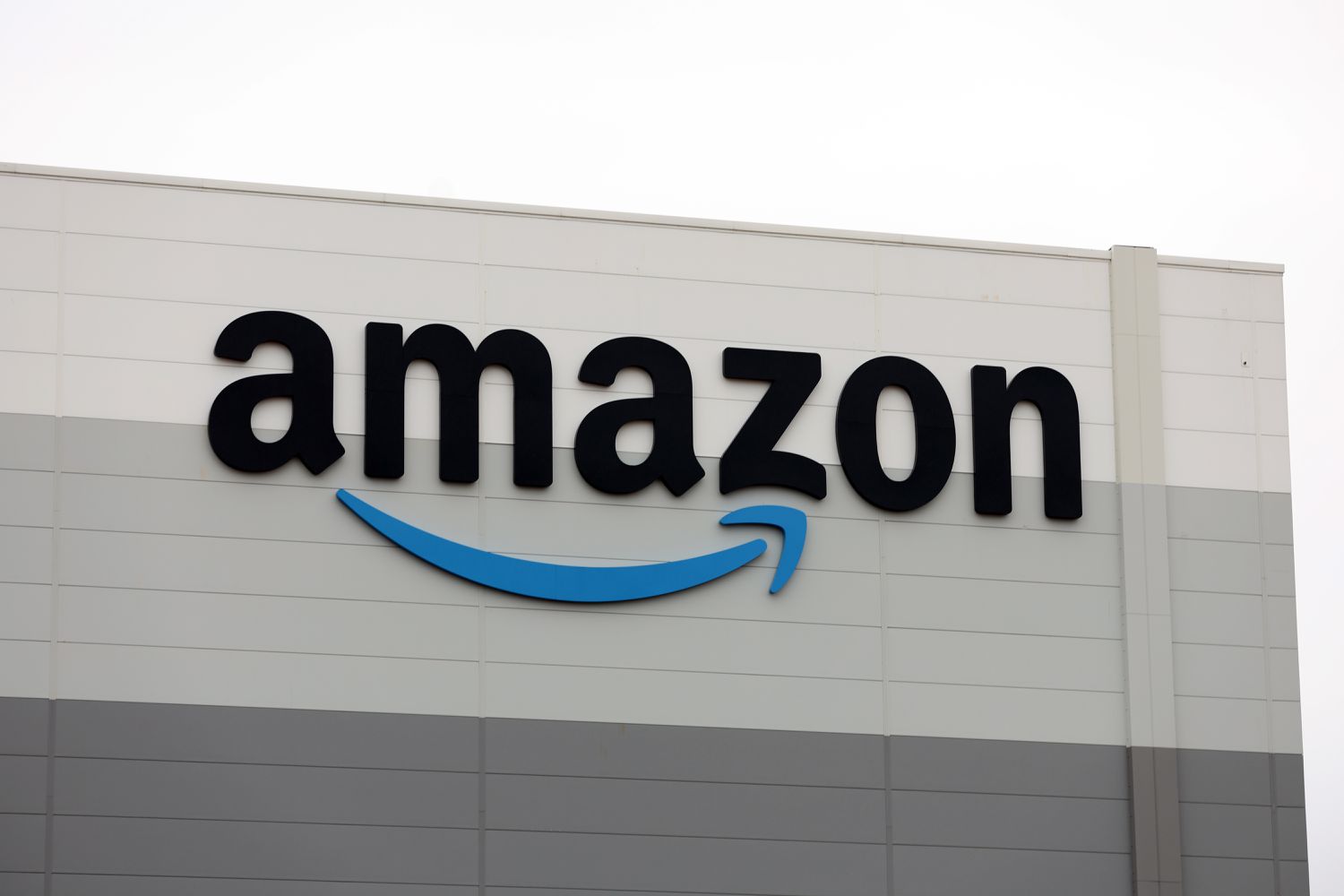 The Amazon logo on display outside of a company location.