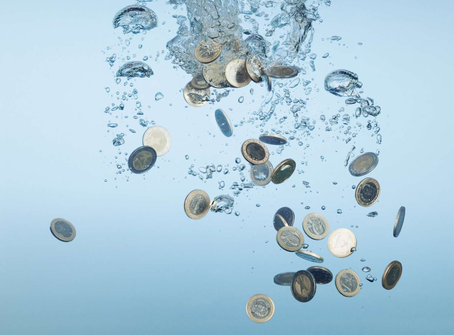 euro coins sinking in water