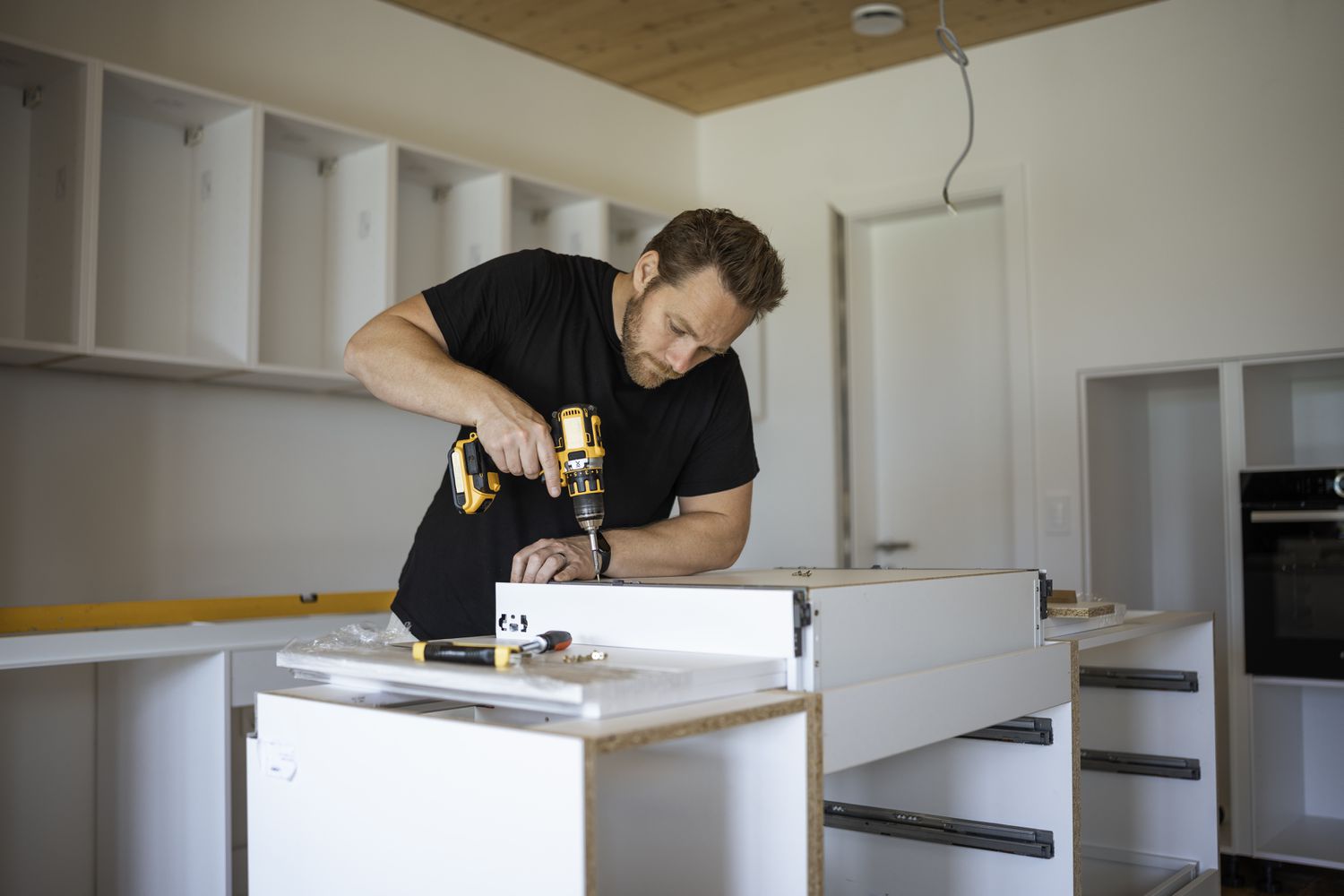 A man remodels a kitchen