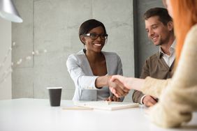 Couple sitting in a meeting with their financial advisor.