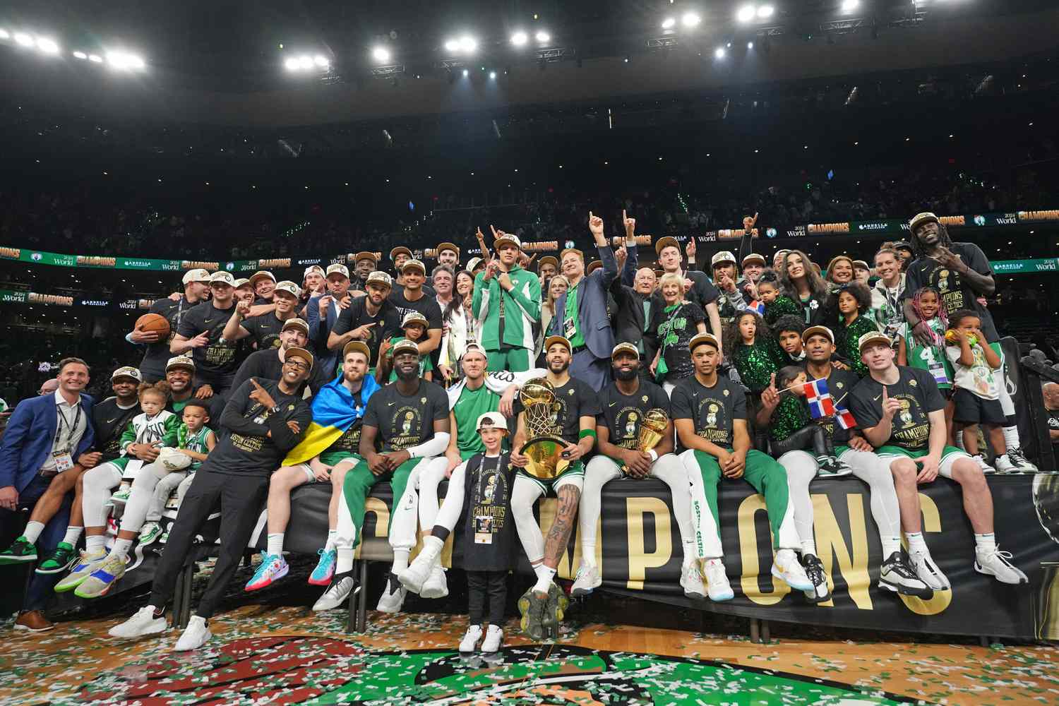 The Boston Celtics pose for a photo with the Larry O'Brien Trophy and the The Bill Russell Finals MVP Trophy after the game against the Dallas Mavericks during Game 5 of the 2024 NBA Finals on June 17, 2024 at the TD Garden in Boston