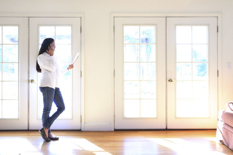 Woman touring a house she's planning to buy after recently recovering from bankruptcy