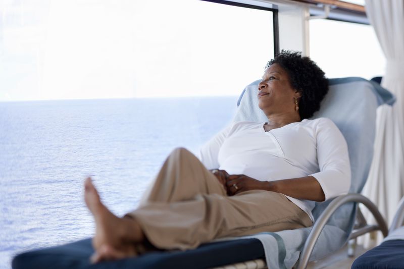 Woman on a cruise lounging on a deck chair.