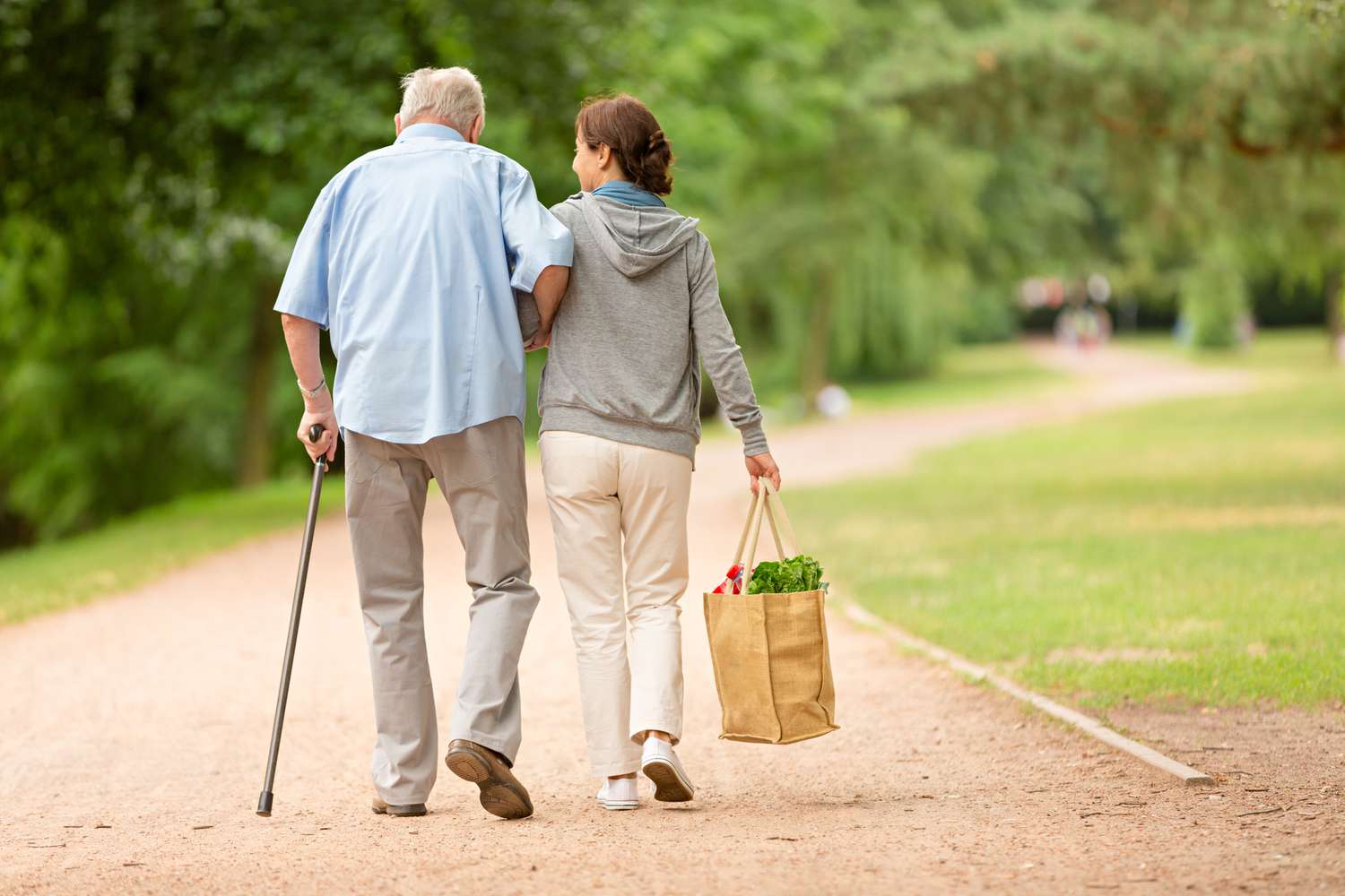 A woman helping senior man with shopping.