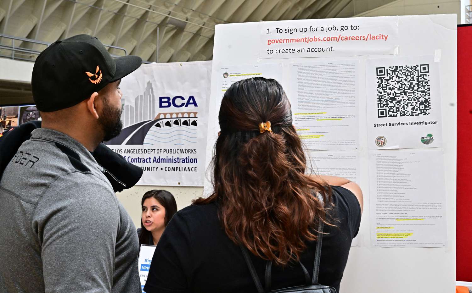 Job seekers read instructions during a career fair where job seekers can meet with prospective employers during a City of Los Angeles career fair offering to fill vacancies in more than 30 classifications of jobs on November 2, 2023 in Los Angeles, California. 