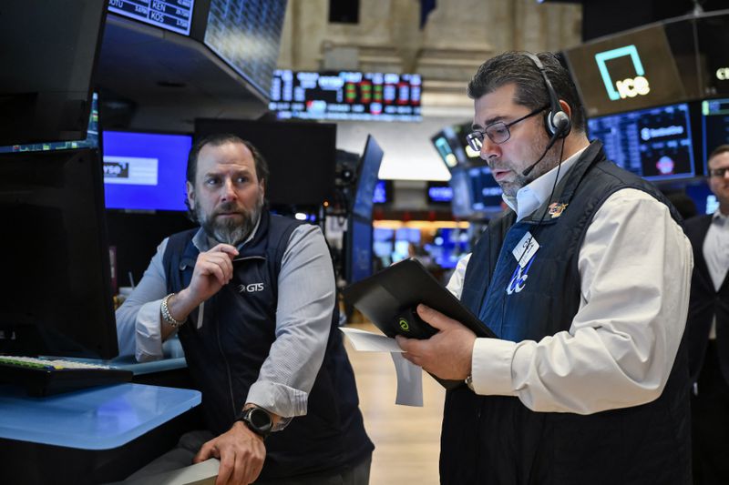 Traders work on the floor of the New York Stock Exchange.