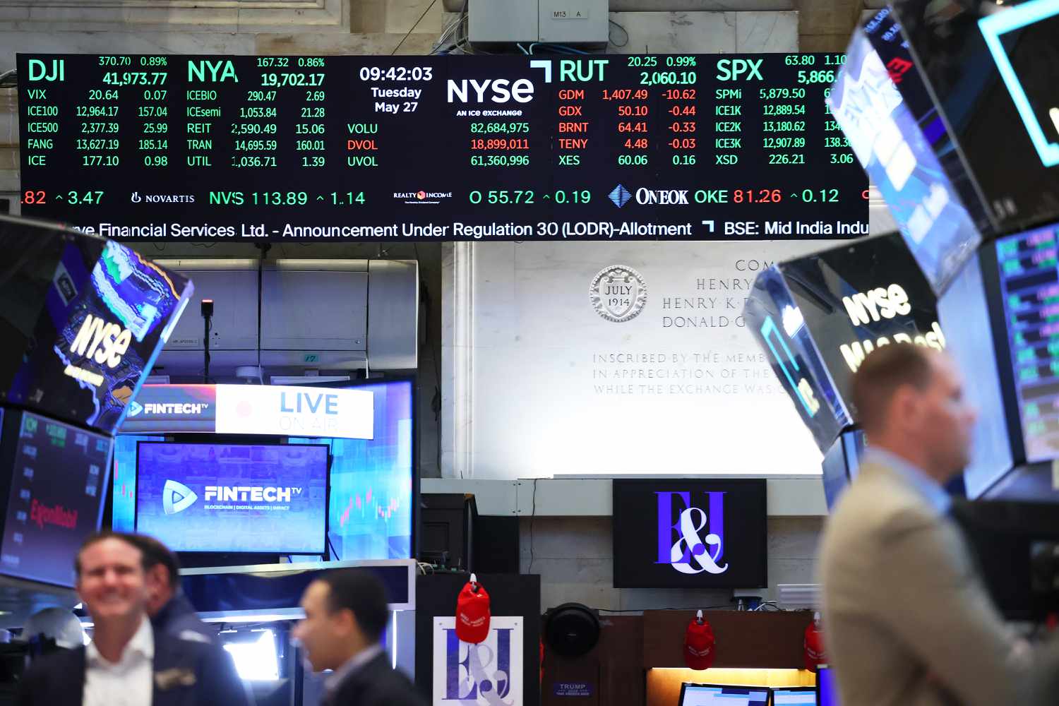 Stock market numbers are seen as traders work on the floor of the New York Stock Exchange.
