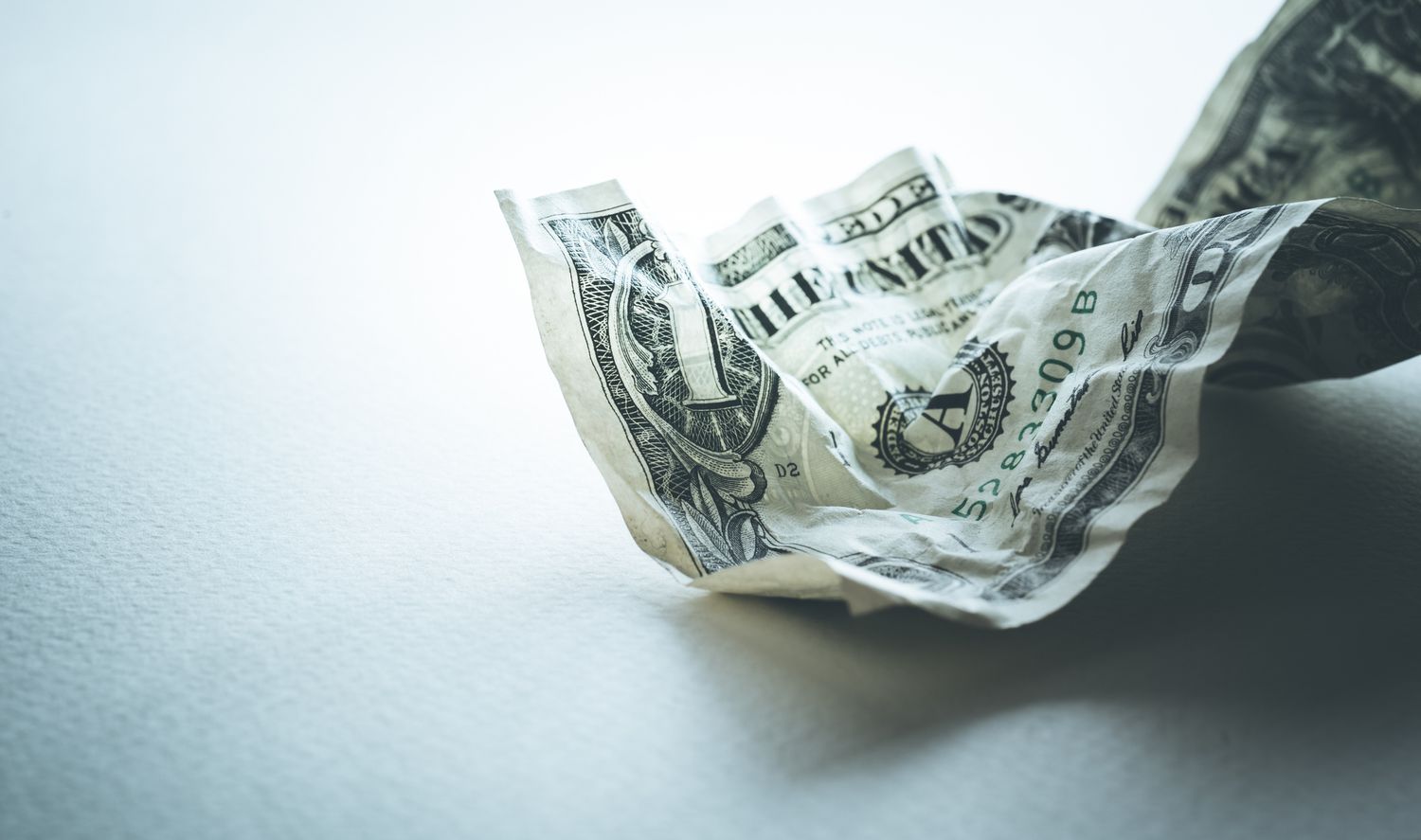 A crumpled up dollar bill
