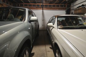 Two cars tightly parked in a two car garage