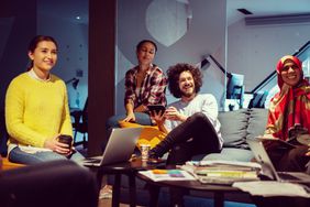 Group of young business people listening to a speaker