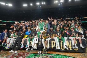 The Boston Celtics pose for a photo with the Larry O'Brien Trophy and the The Bill Russell Finals MVP Trophy after the game against the Dallas Mavericks during Game 5 of the 2024 NBA Finals on June 17, 2024 at the TD Garden in Boston
