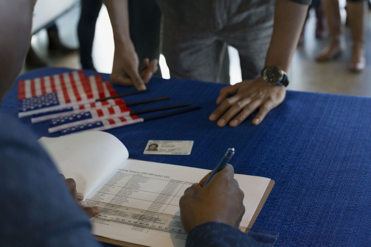 A volunteer checking voters in at polling place.