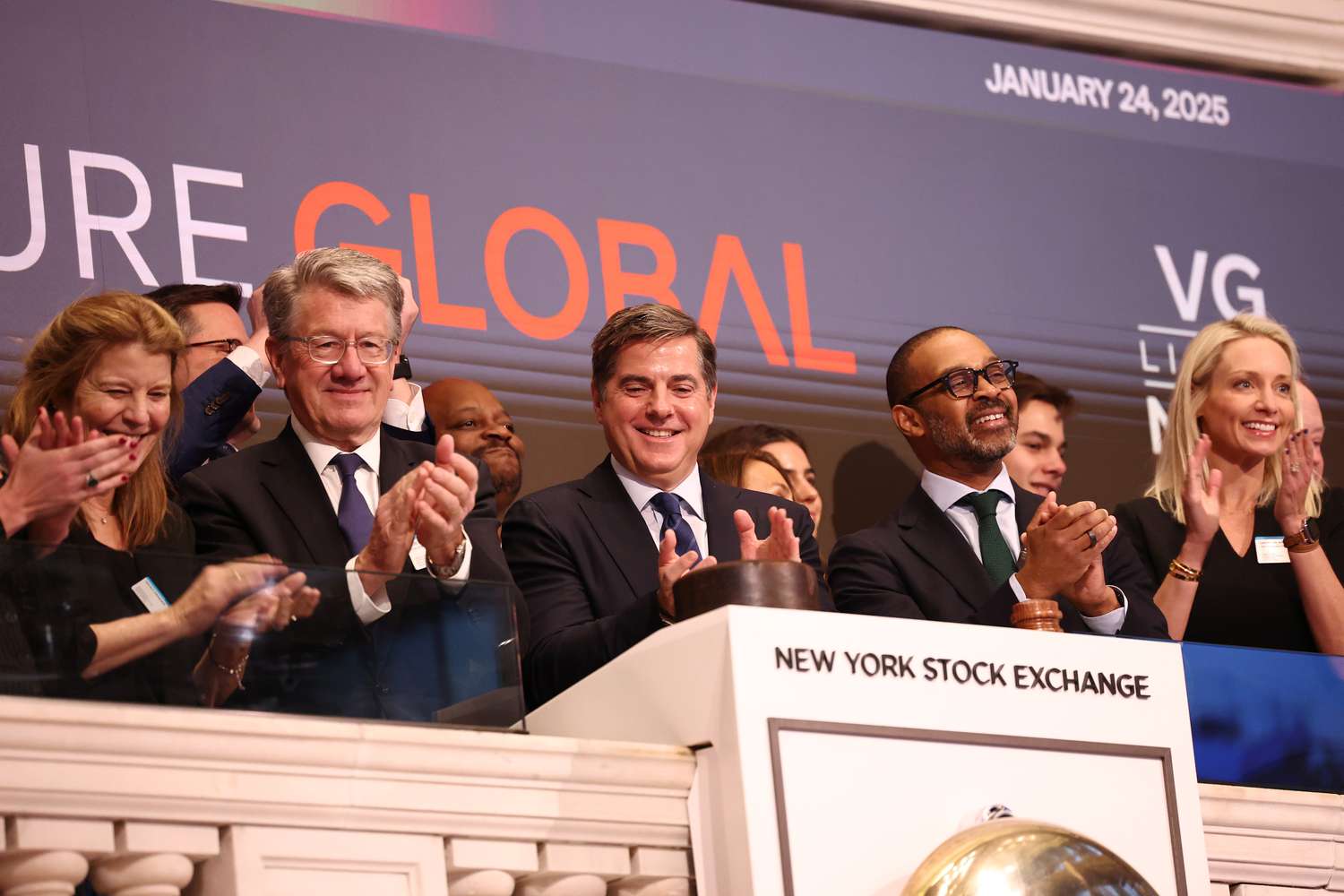 Employees and executives from Venture Global ring the opening bell of the New York Stock Exchange, with the Venture Global logo visible in the backrgound