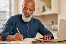 Man reviewing the term payment plan for his reverse mortgage. 