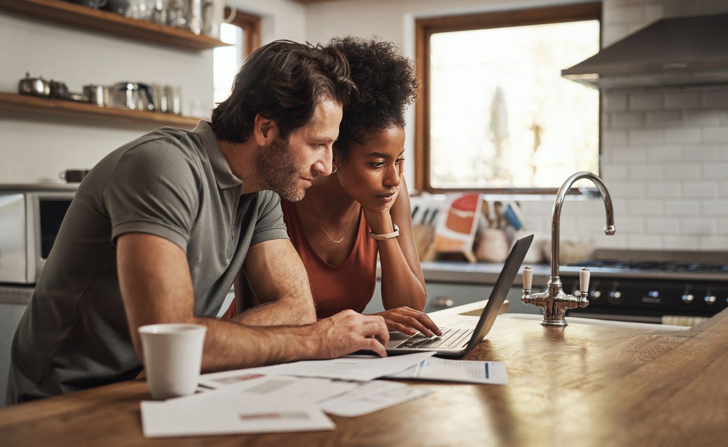 Young couple working on laptop at home