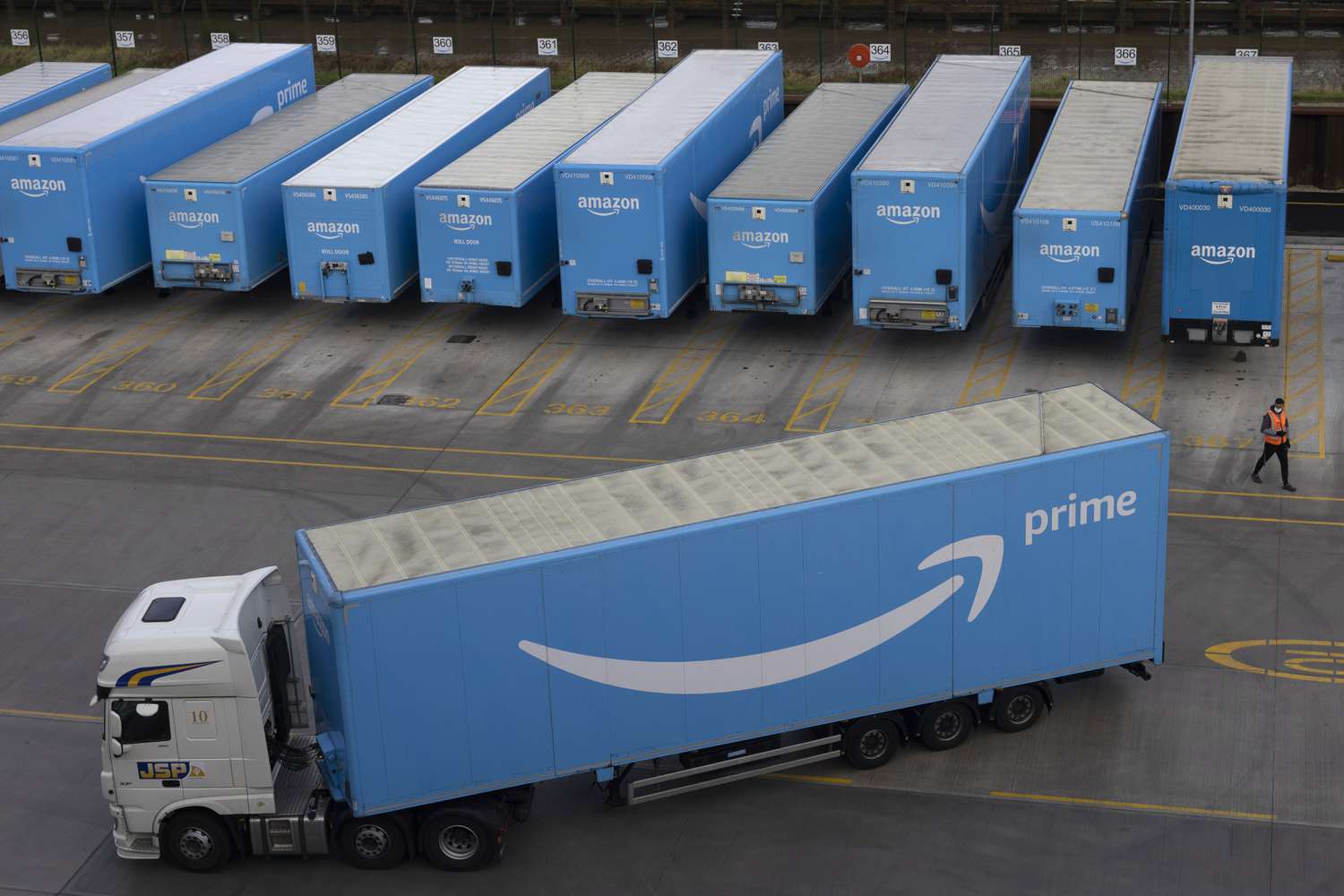 Amazon trucks at a company fulfillment center in London