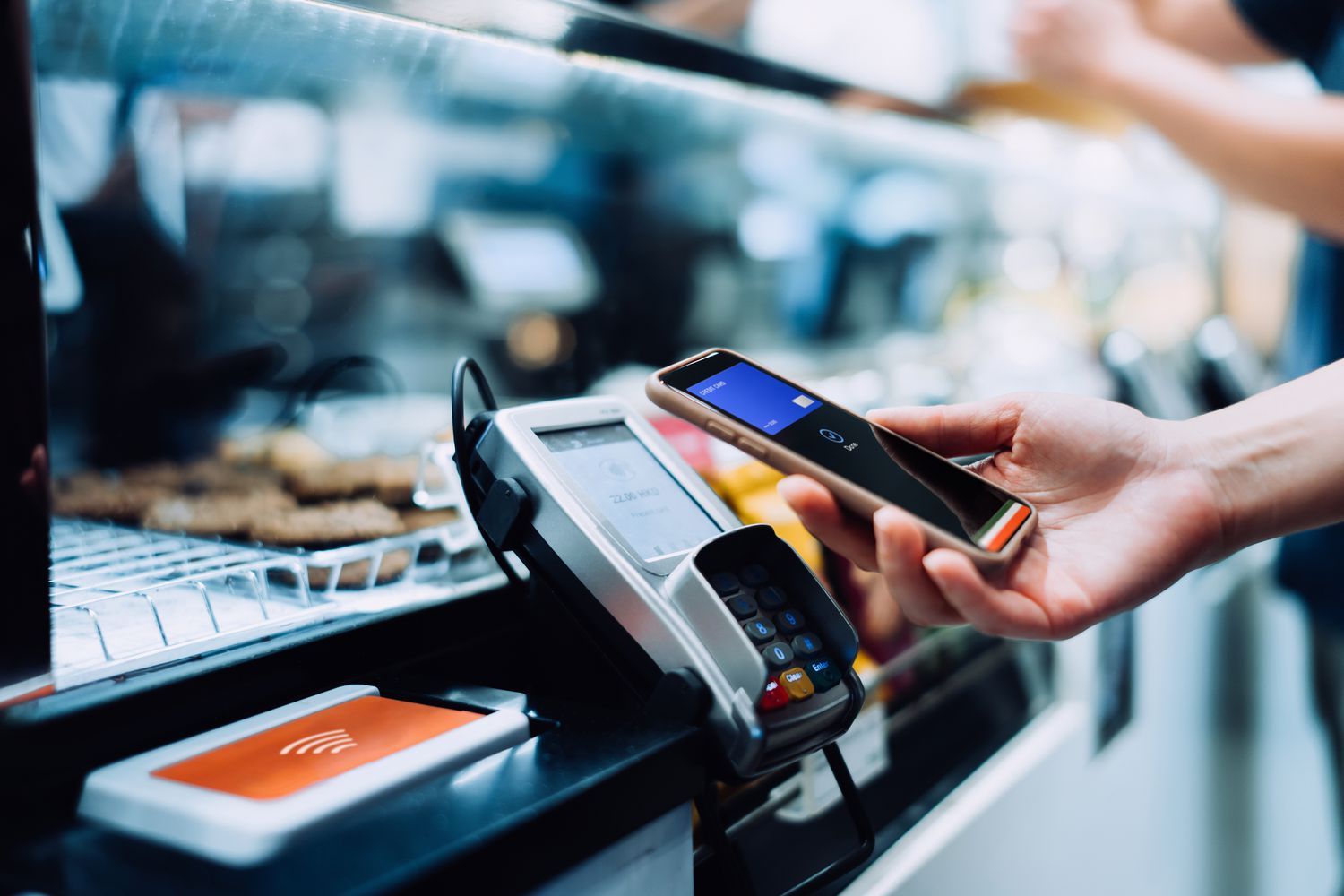Person's hand engaging in a contactless digital transaction