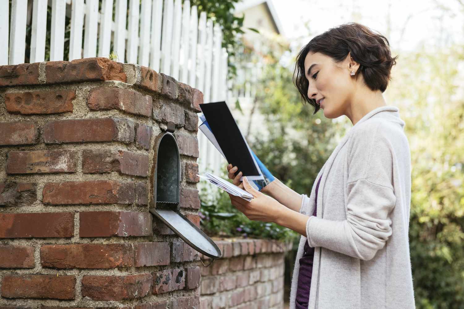 Woman checking her mailbox for her FAFSA award letter