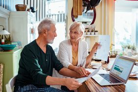 Older couple doing financial planning at home