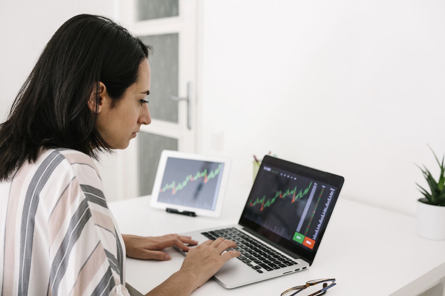Trader looking at stock charts and deciding to invest in a speculative stock.