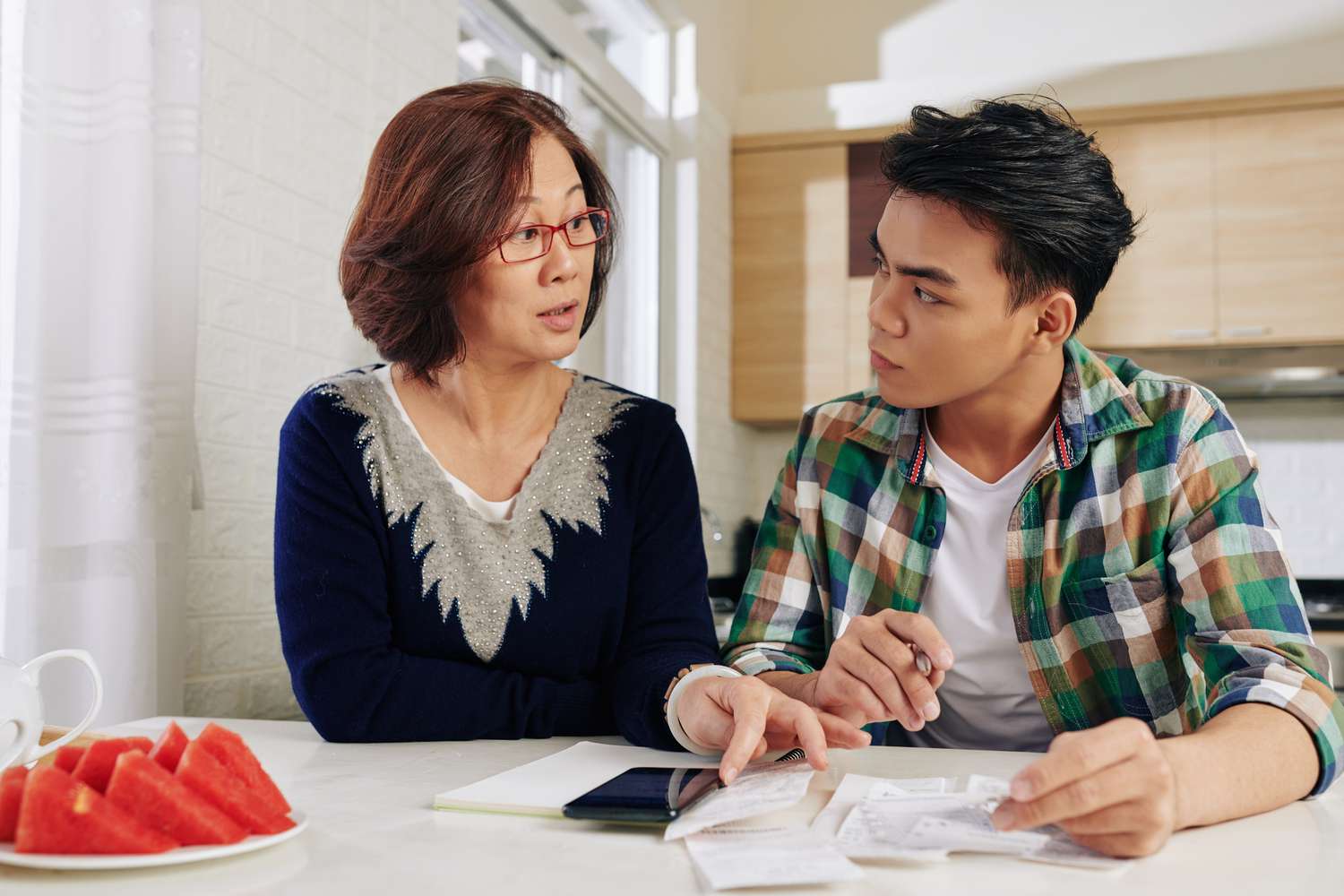 Mother and child comparing college savings accounts in the U.S. vs. Canada