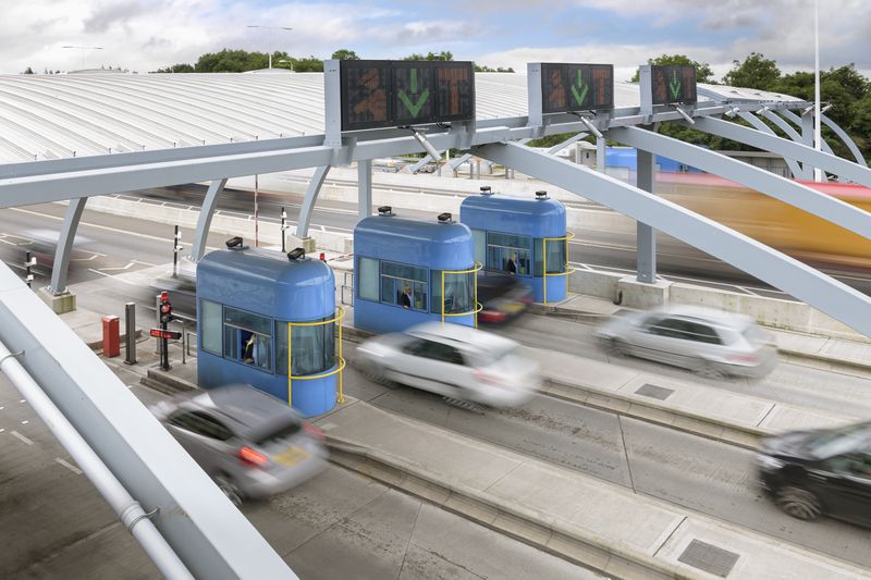 Cars travelling through toll booth at bridge, high angle view