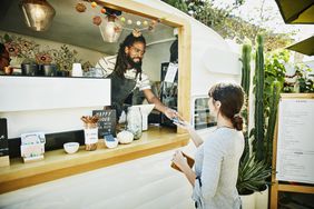 Food truck owner takes credit card payment from customer