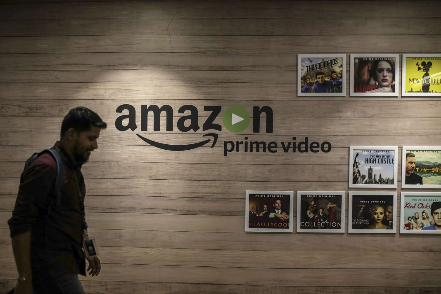An employee walks past a wall display for Amazon.com Inc.'s Prime Video streaming service at the company's office in Hyderbad, India