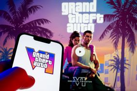 Grand Theft Auto VI displayed on a smartphone in front of larger GTA image.