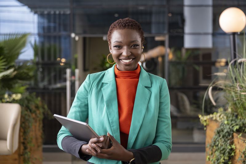 black business woman portrait with iPad in hand