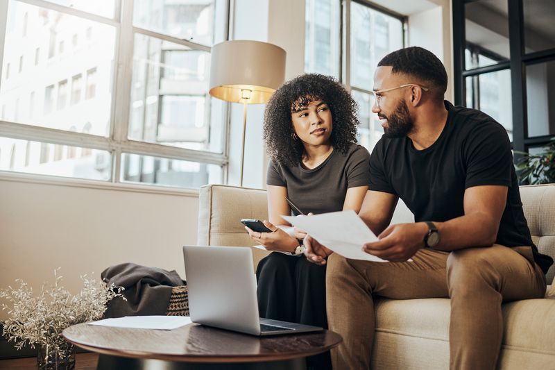 A couple with documents has a discussion.