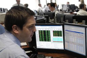 Investor looking at his positions on a computer monitor