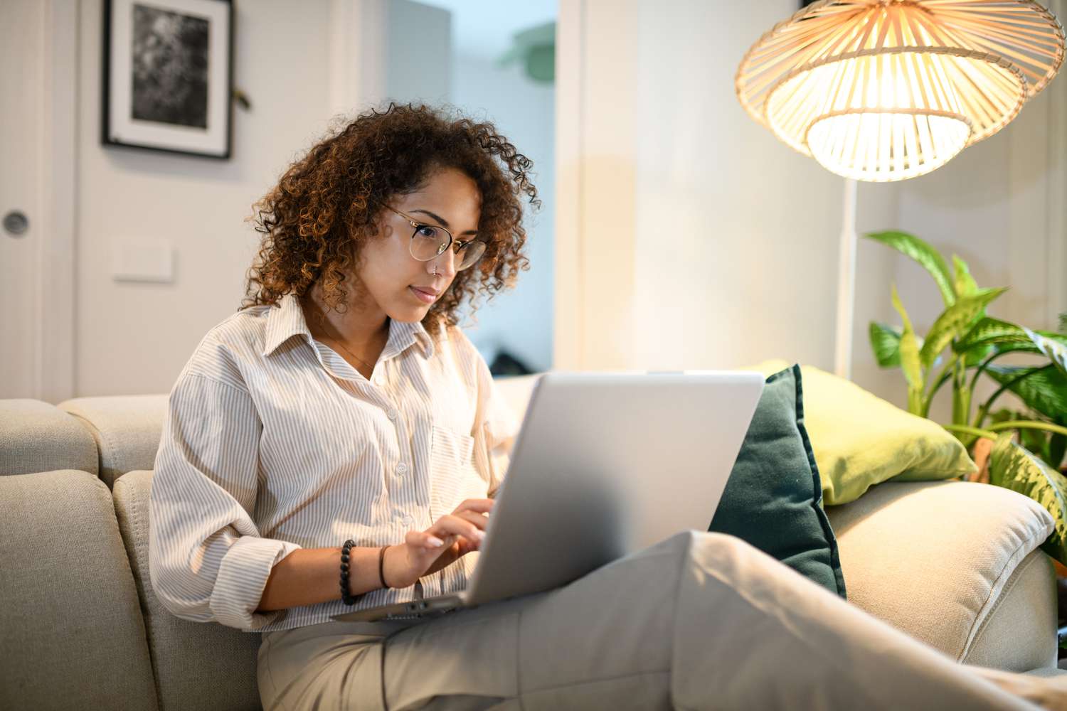 Woman using laptop computer on a couch