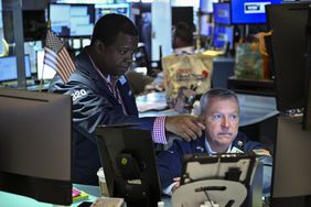Traders work on the floor of the New York Stock Exchange