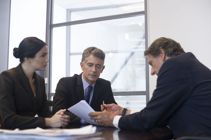 A business meeting with associates analyzing documents.