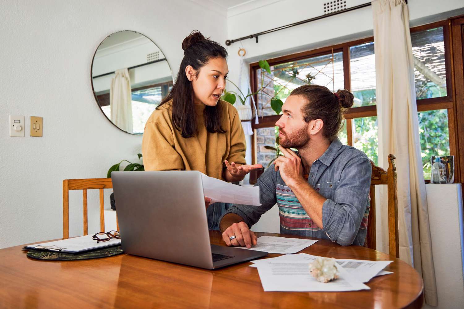 Troubled young couple in a heated argument when checking their finances at home