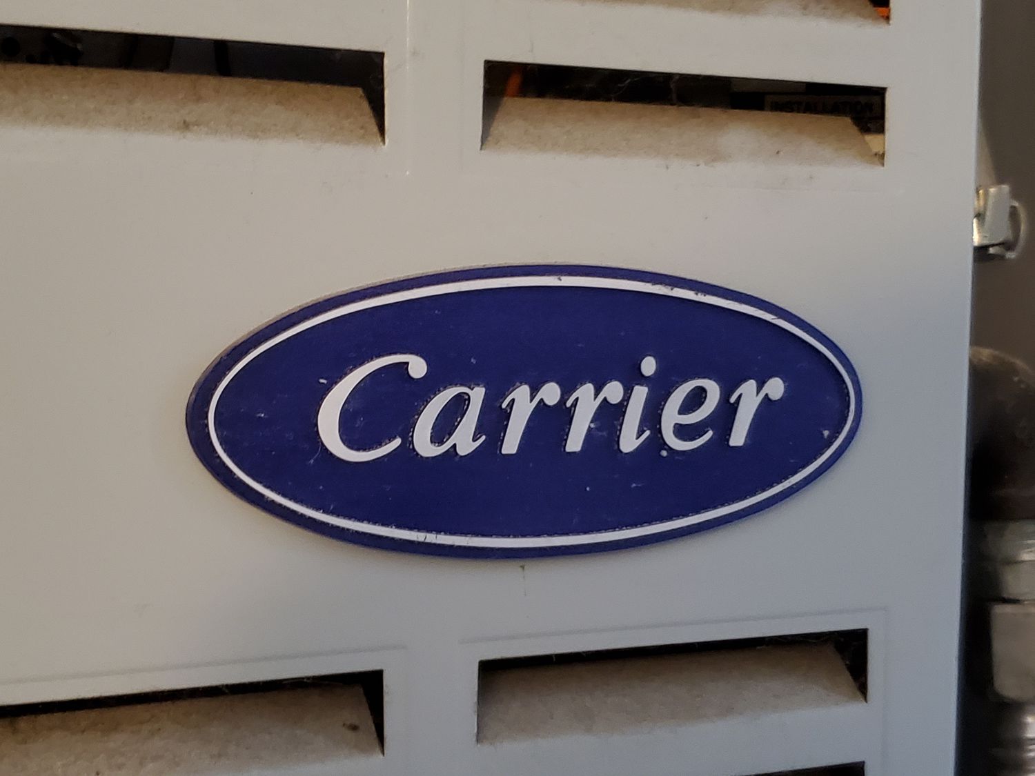 Close-up of logo for HVAC systems company Carrier on heat pump unit