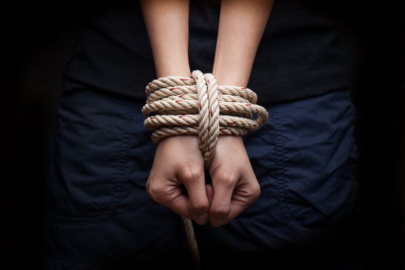 Hands with rope around them