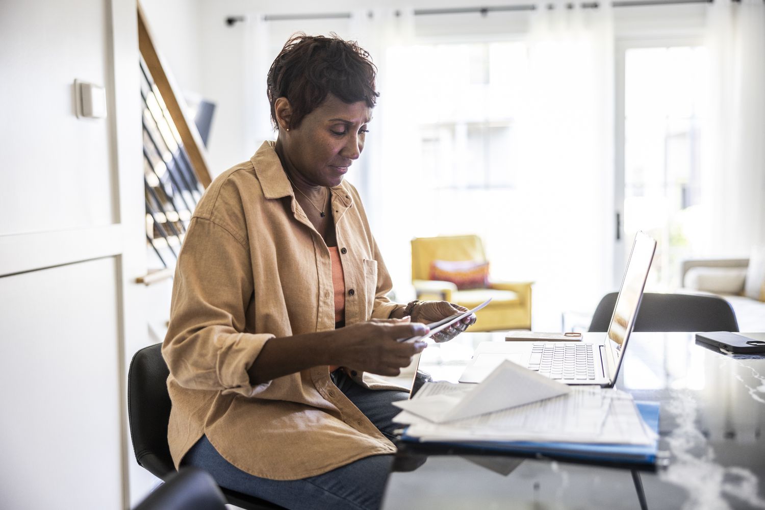 Senior woman applying for mortage using her laptop at home