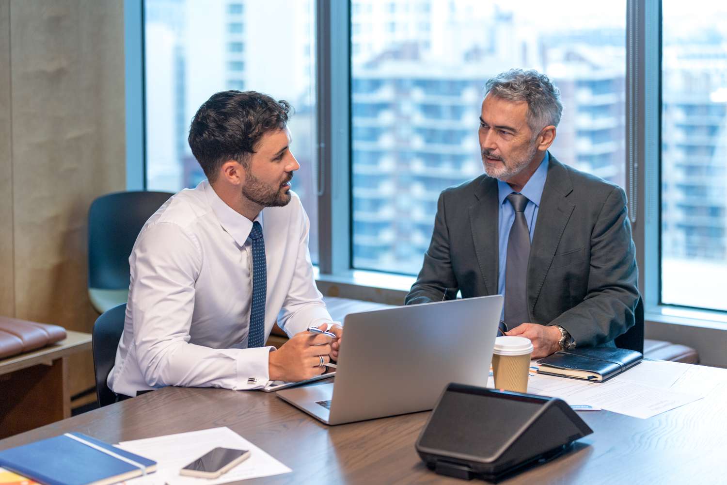 Two men talking in an office