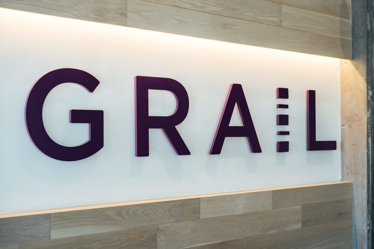 The Grail logo is seen on a white wall