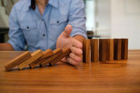Cropped Image Of Man Playing With Domino On Table