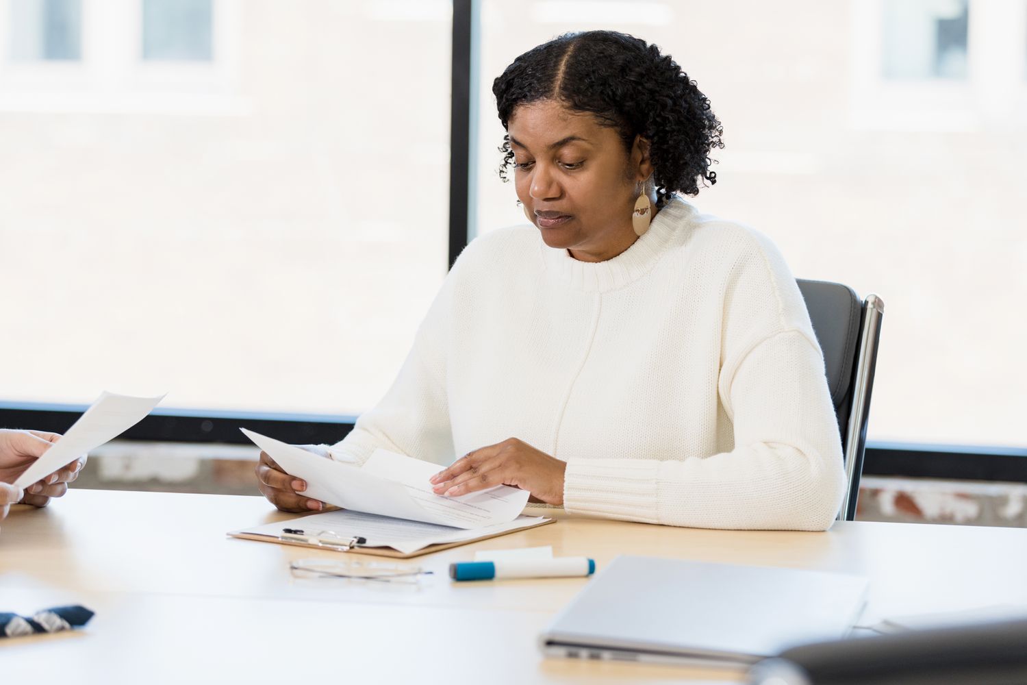 Woman sitting at a desk, studying documents