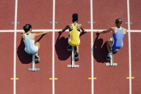 Racers on track knelt down about to start race