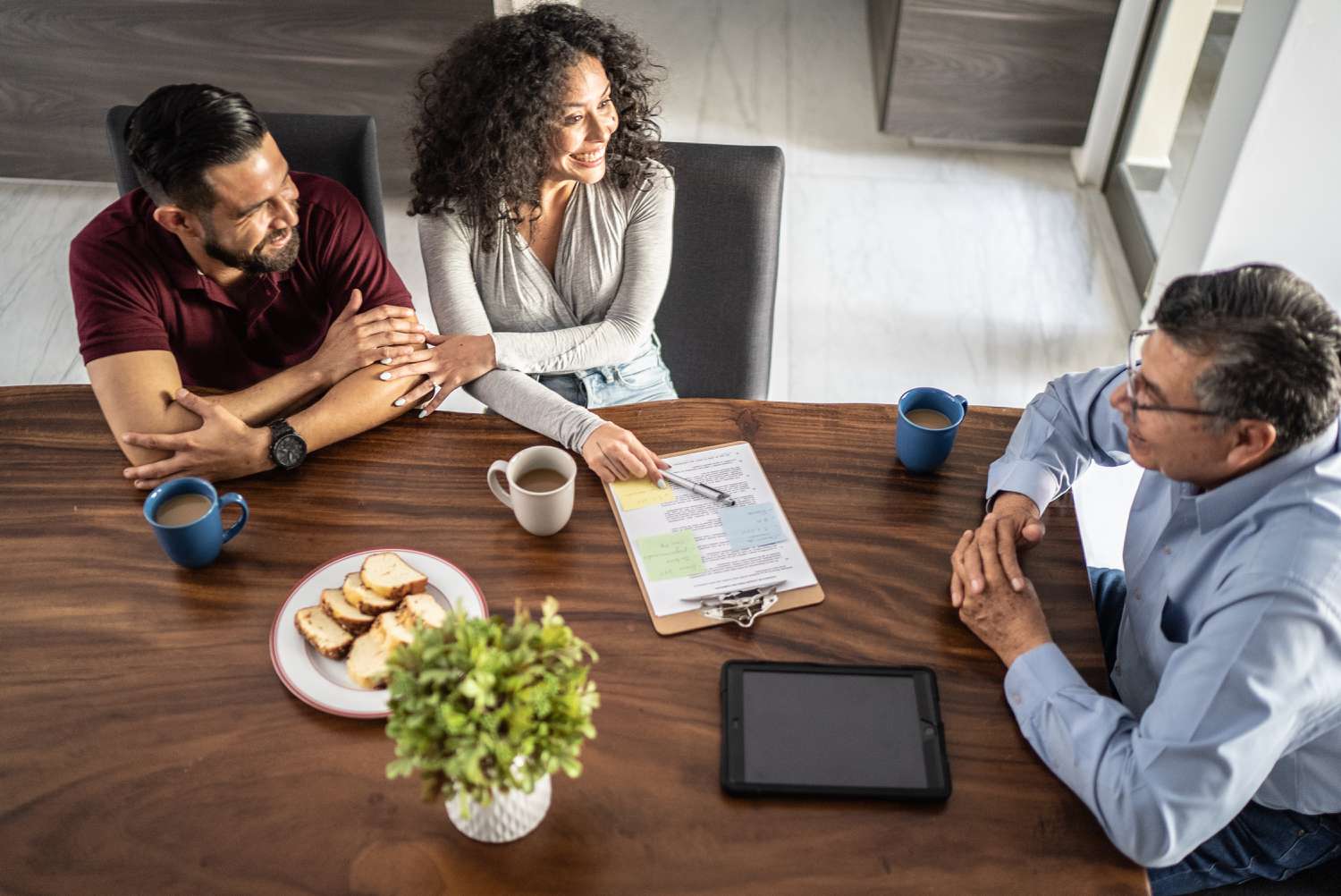 A couple signs the purchase contract of a house that is a best efforts mortgage lock through a mortgage originator.